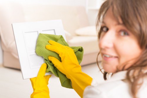Staff performing detailed commercial cleaning in a workplace
